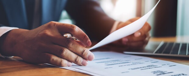 man-in-suit-filling-out-a-resume