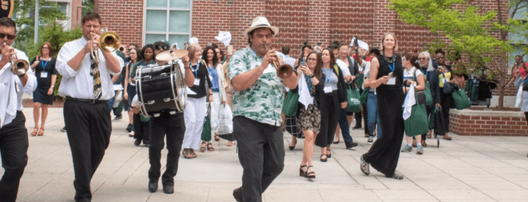 New Orleans band playing brass instruments and drums for audience on Tulane campus