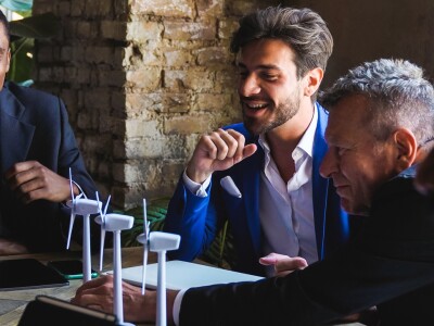 group around table looking at prototype of wind energy
