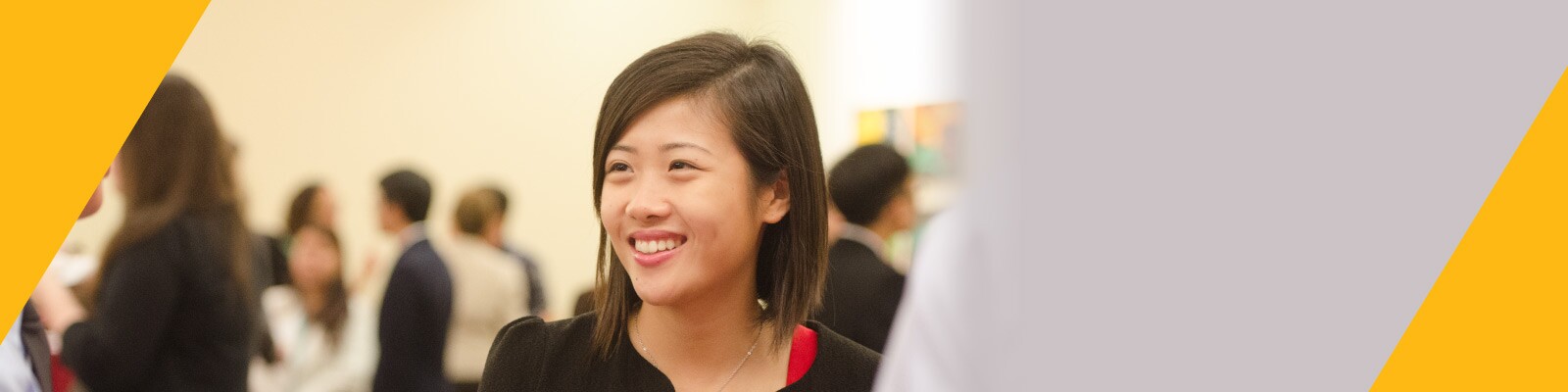 Woman smiles confidently at networking event