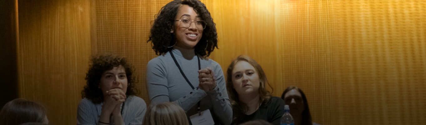 student standing to address a classroom