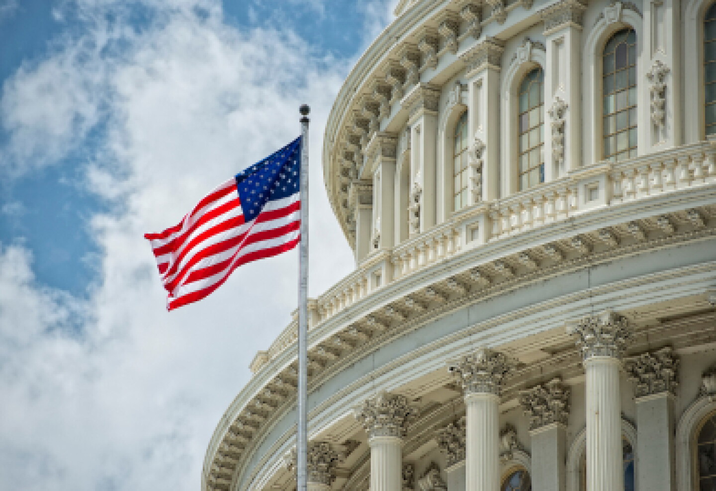 An american flag standing outside a federal government building.