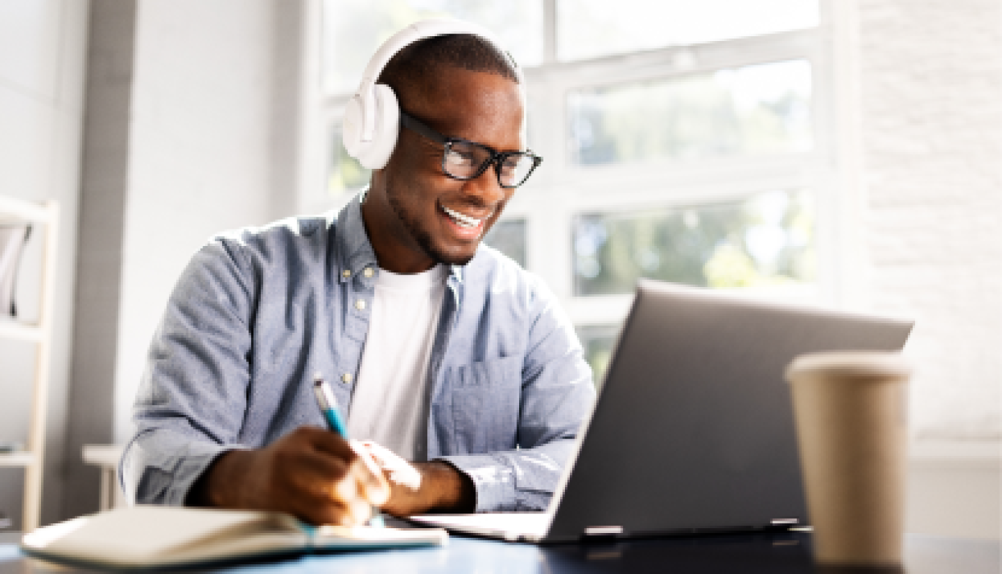 A male CWRU student reviewing online lesson from home office.