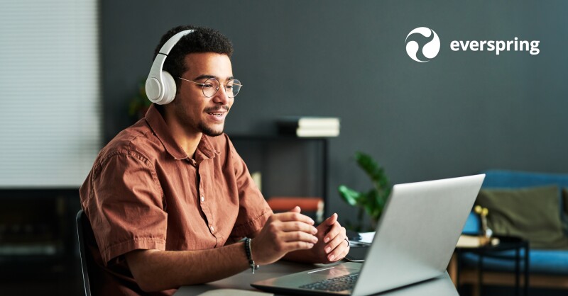 Young student in headphones communicating with online course