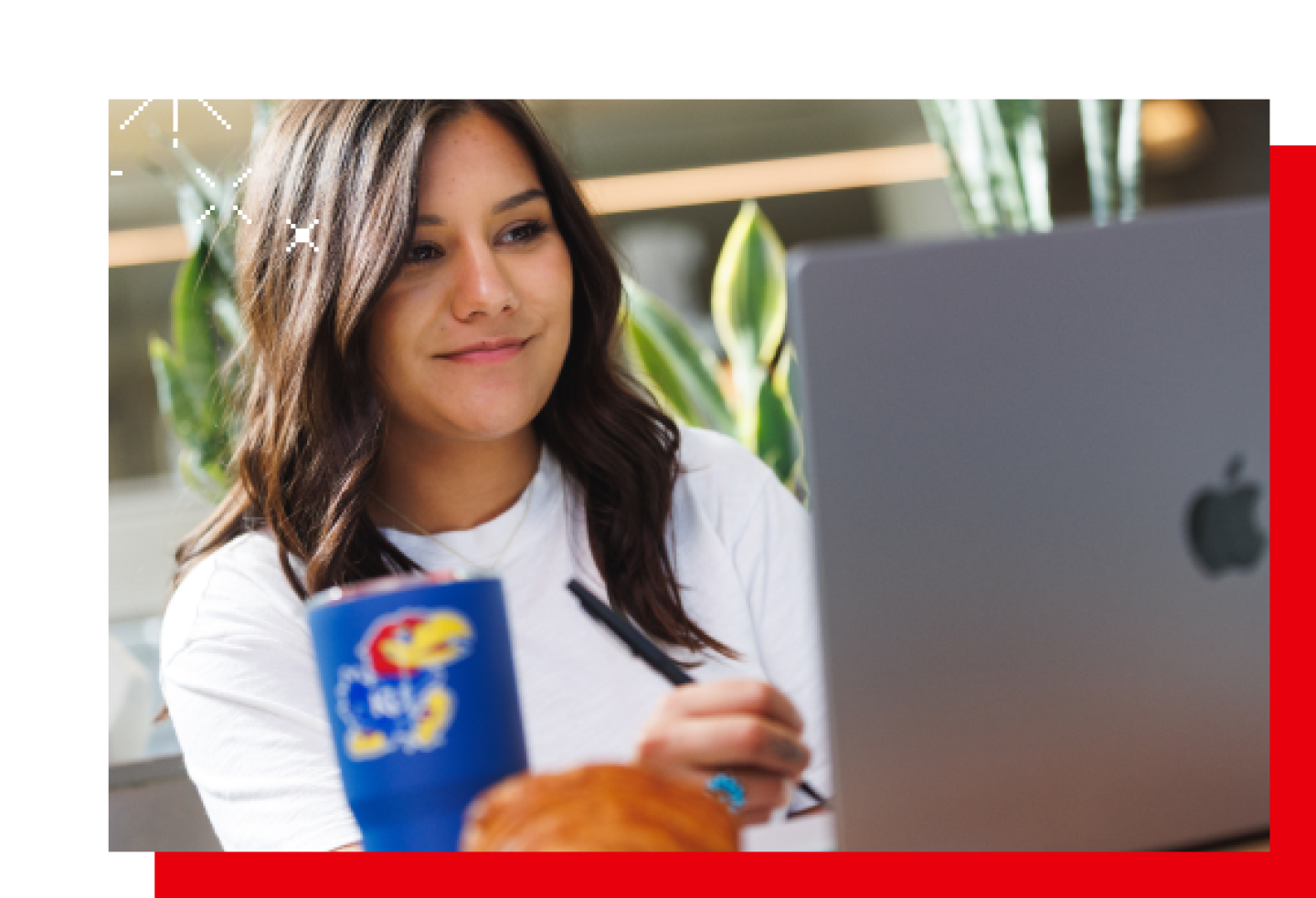 Close-up of a female KU student on laptop.