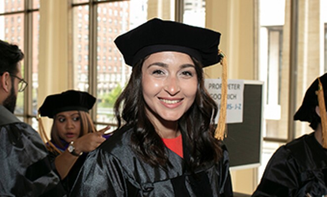 graduate smiling at the camera